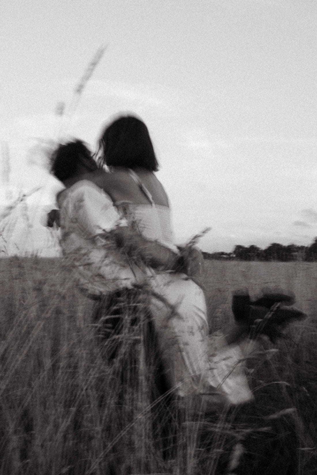 couple hugging outside on a field