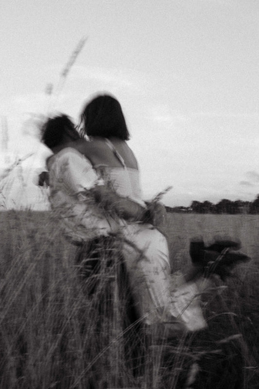 couple hugging outside on a field